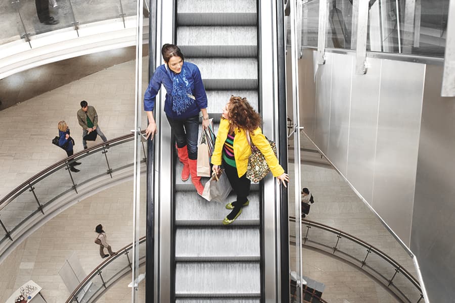 Shoppers ride an escalator up to the Harris Scarfe department store in  Adelaide, South Australia, Australia Stock Photo - Alamy